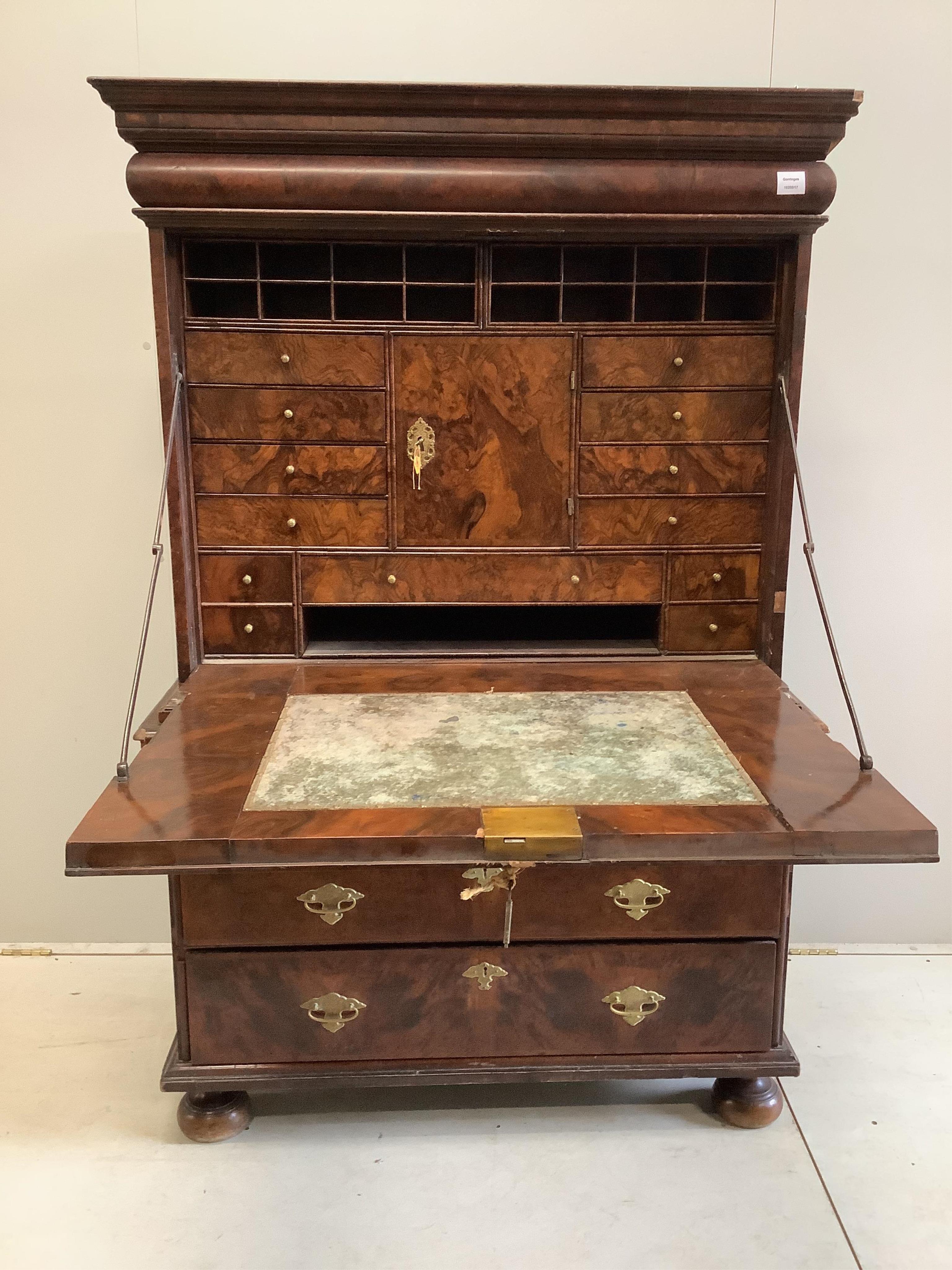 A Queen Anne escritoire, with three long graduated drawers, fall front opening to reveal drawers and pigeon holes, width 110cm, depth 52cm, height 168cm. Condition - fair